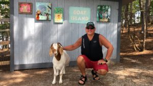 Stephen from Pelican Point Expeditions poses with a goat on Goat Island, Lake Martin Alabama