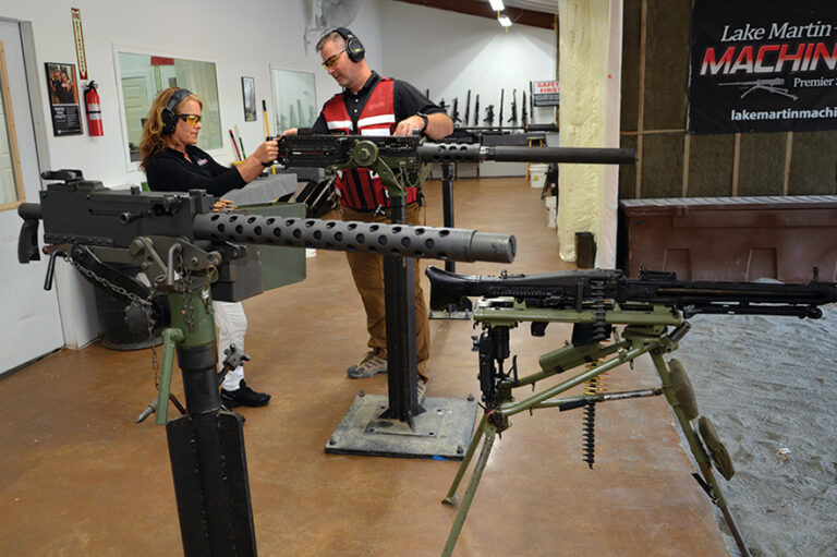 The owners of Lake Martin Machine Gun add bullets to the Ma Deuce machine gun